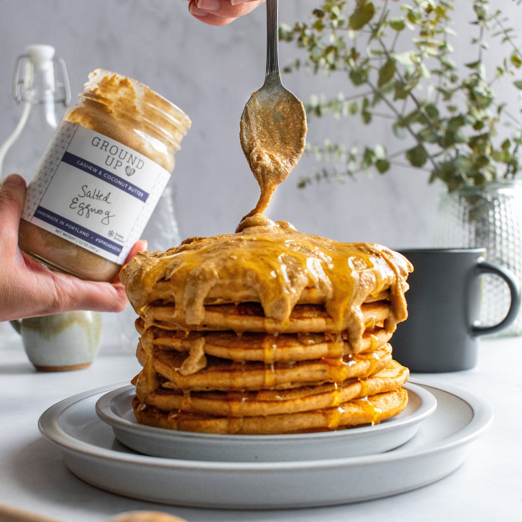 Salted Eggnog cashew and coconut butter drizzled on a stack of pancakes