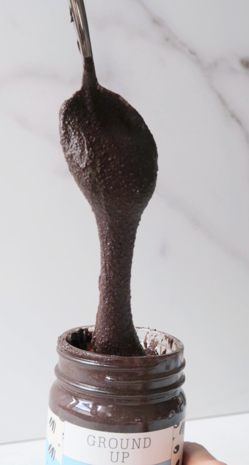 Dark Cocoa Cookie being scooped with a spoon